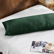 Bamboo body pillow on a bed with a magazine and cup of coffee nearby.