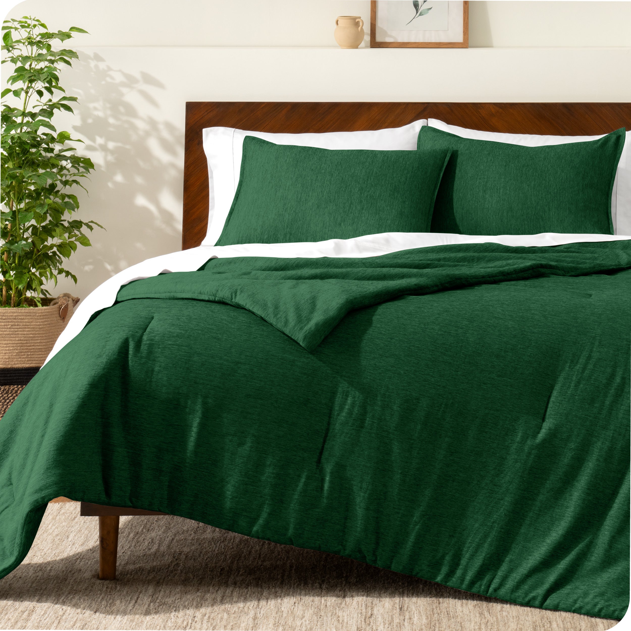 A modern bed with a down alternative comforter set on it

