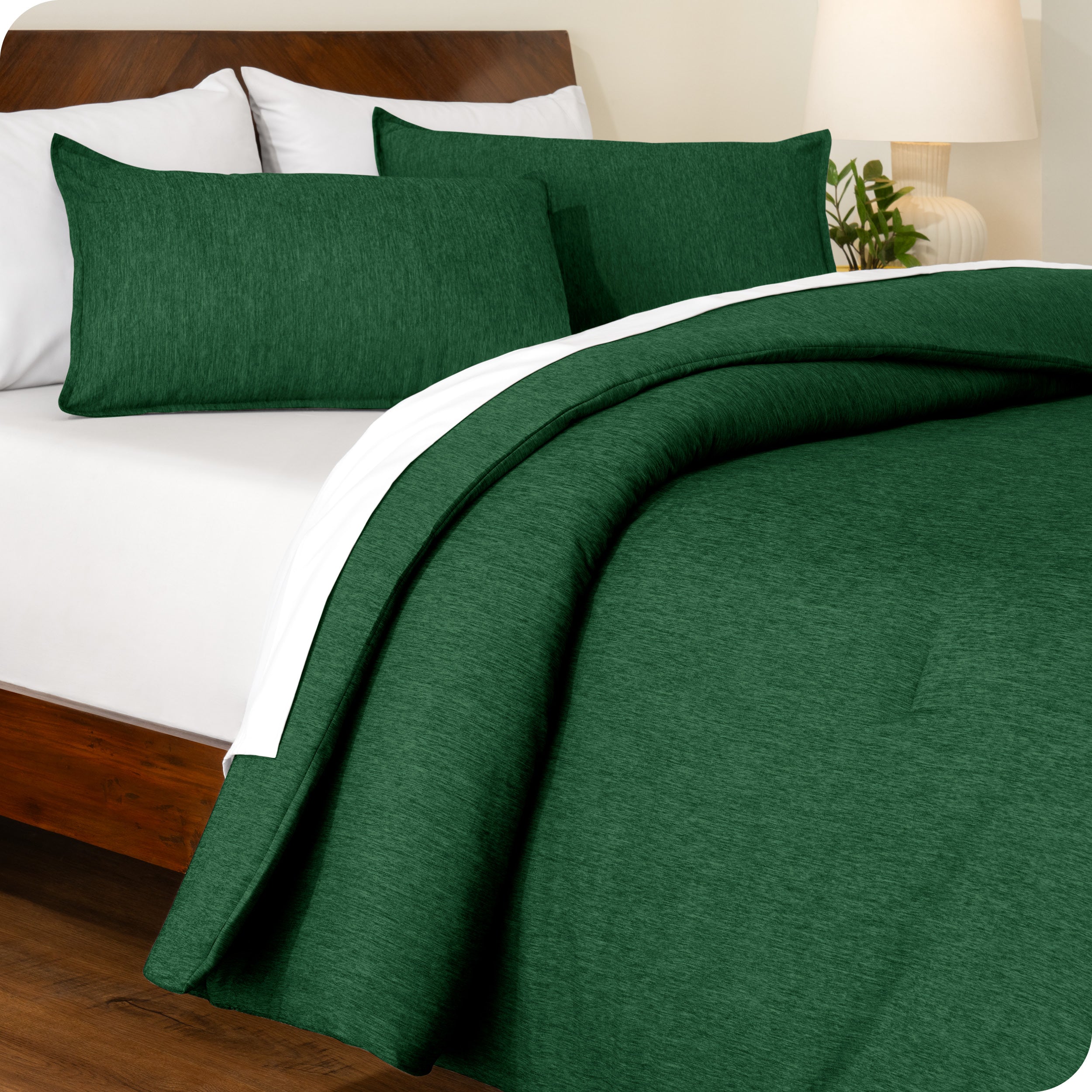 A side view of a modern bed with a comforter set and pillow shams on the bed
