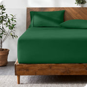 A modern bed with a fitted microfiber sheet made on the mattress. 