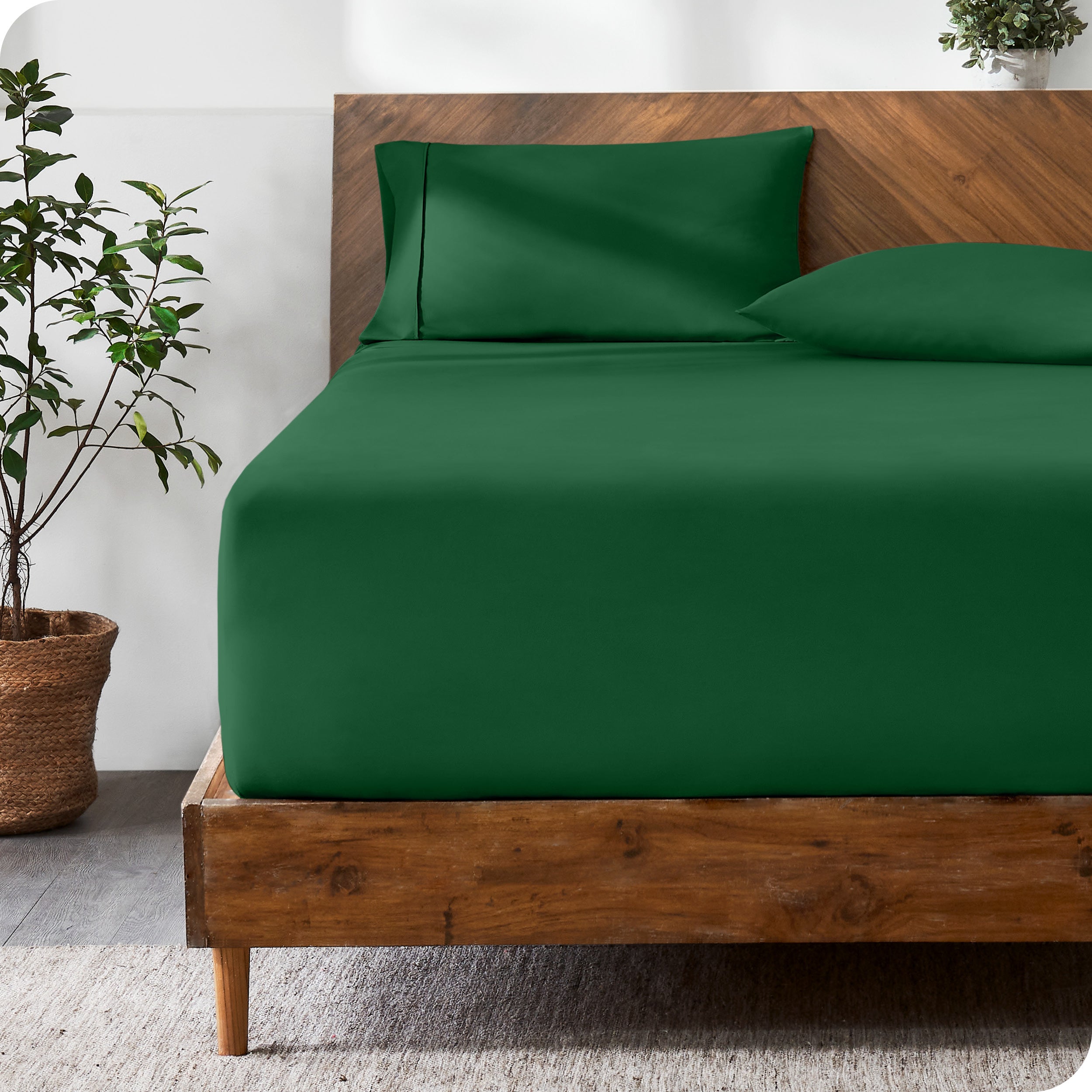 A modern bed with a fitted microfiber sheet made on the mattress. 