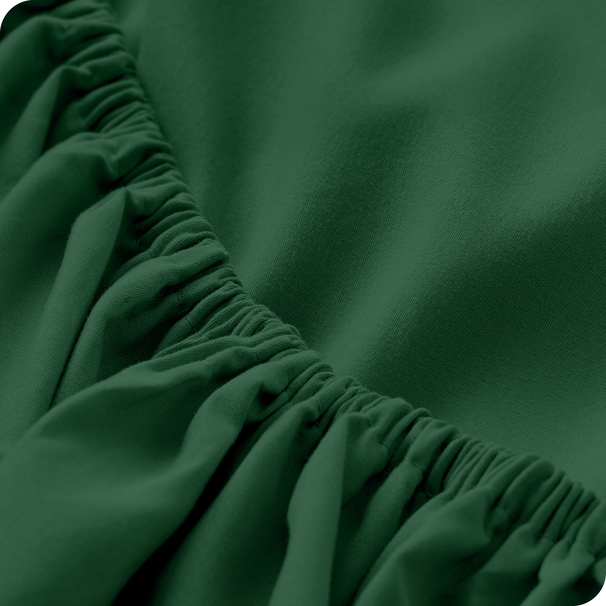A close up of the elastic of a microfiber fitted sheet. 