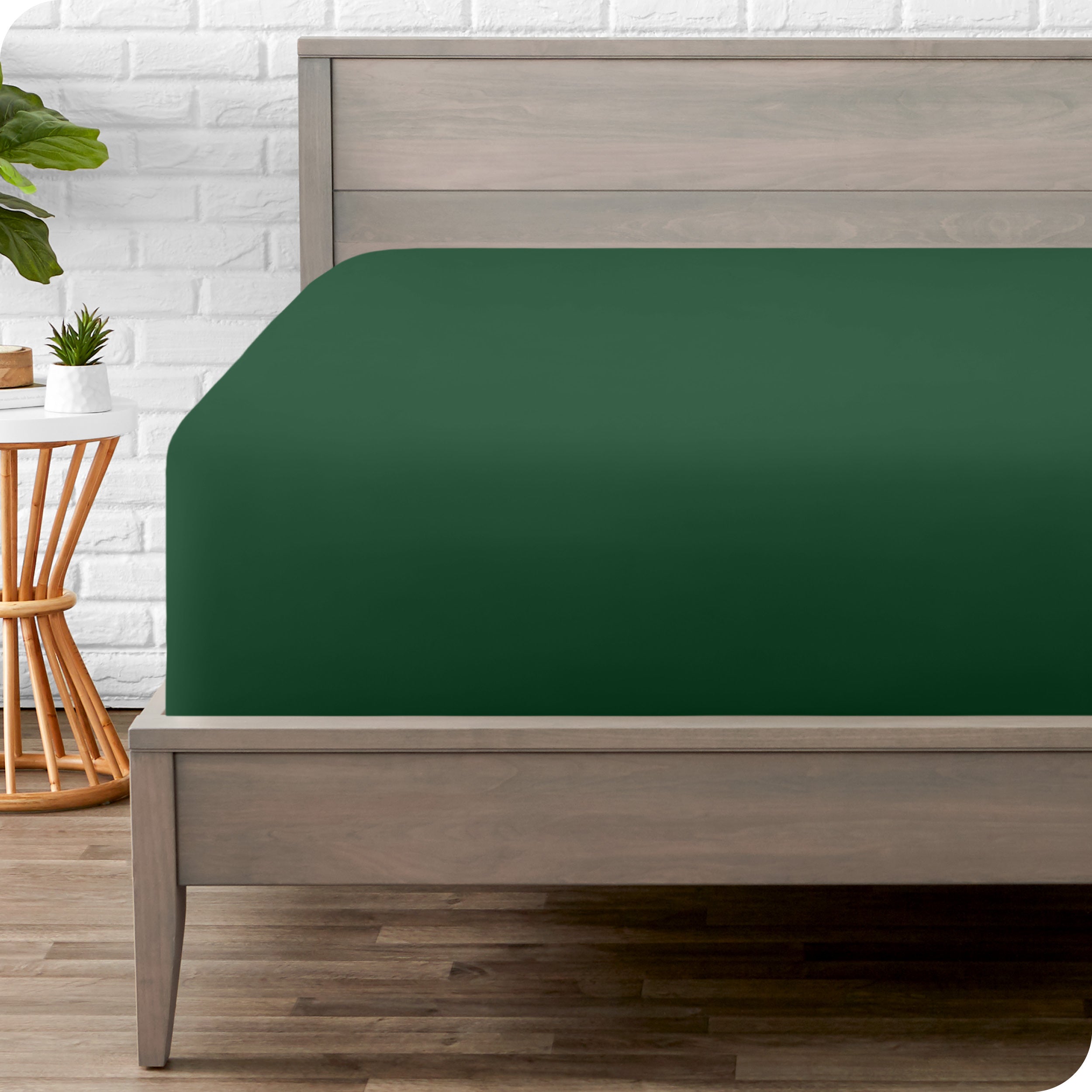 A modern bed with a fitted microfiber sheet on it
