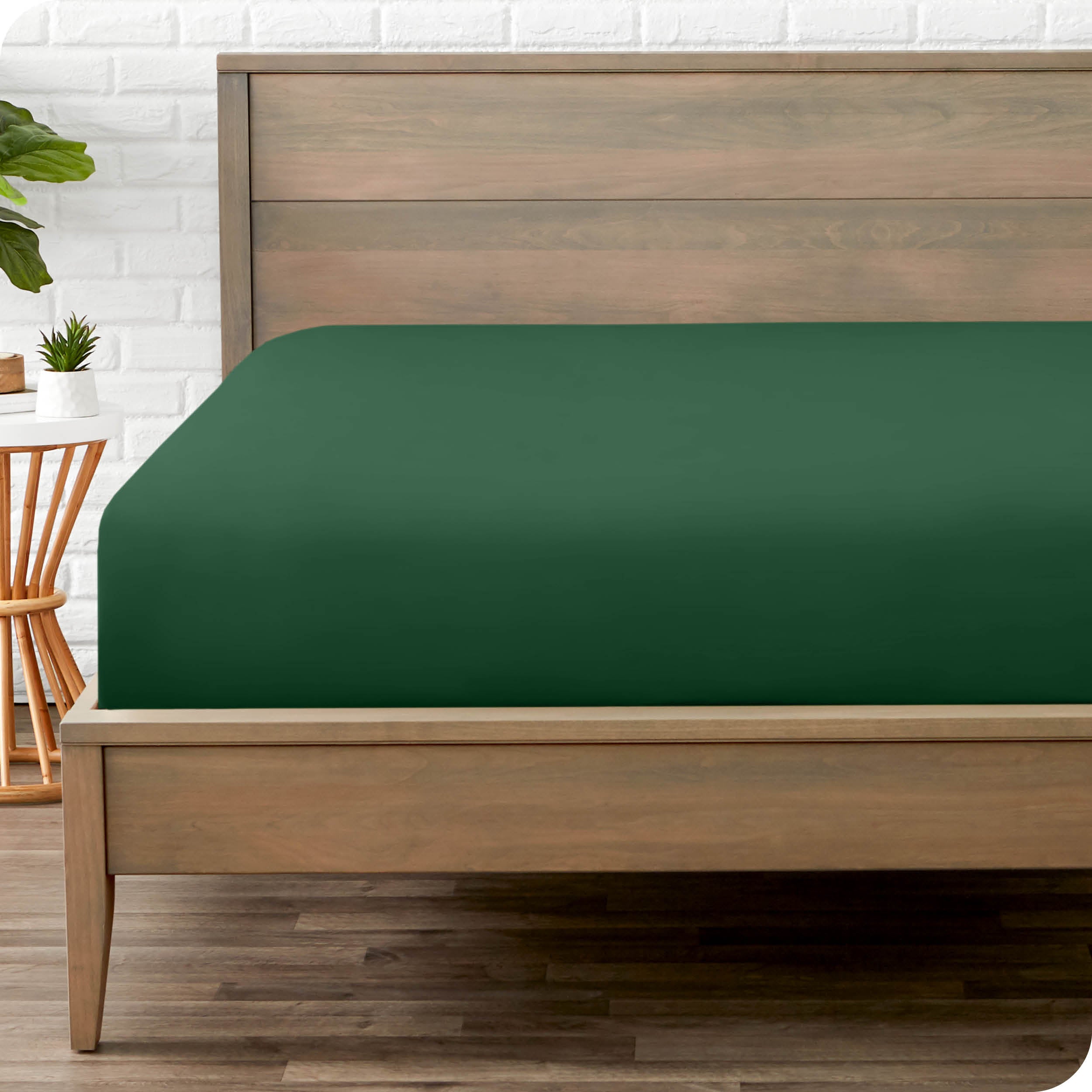 End of bed view with fitted sheet made on the mattress of a modern bed. 