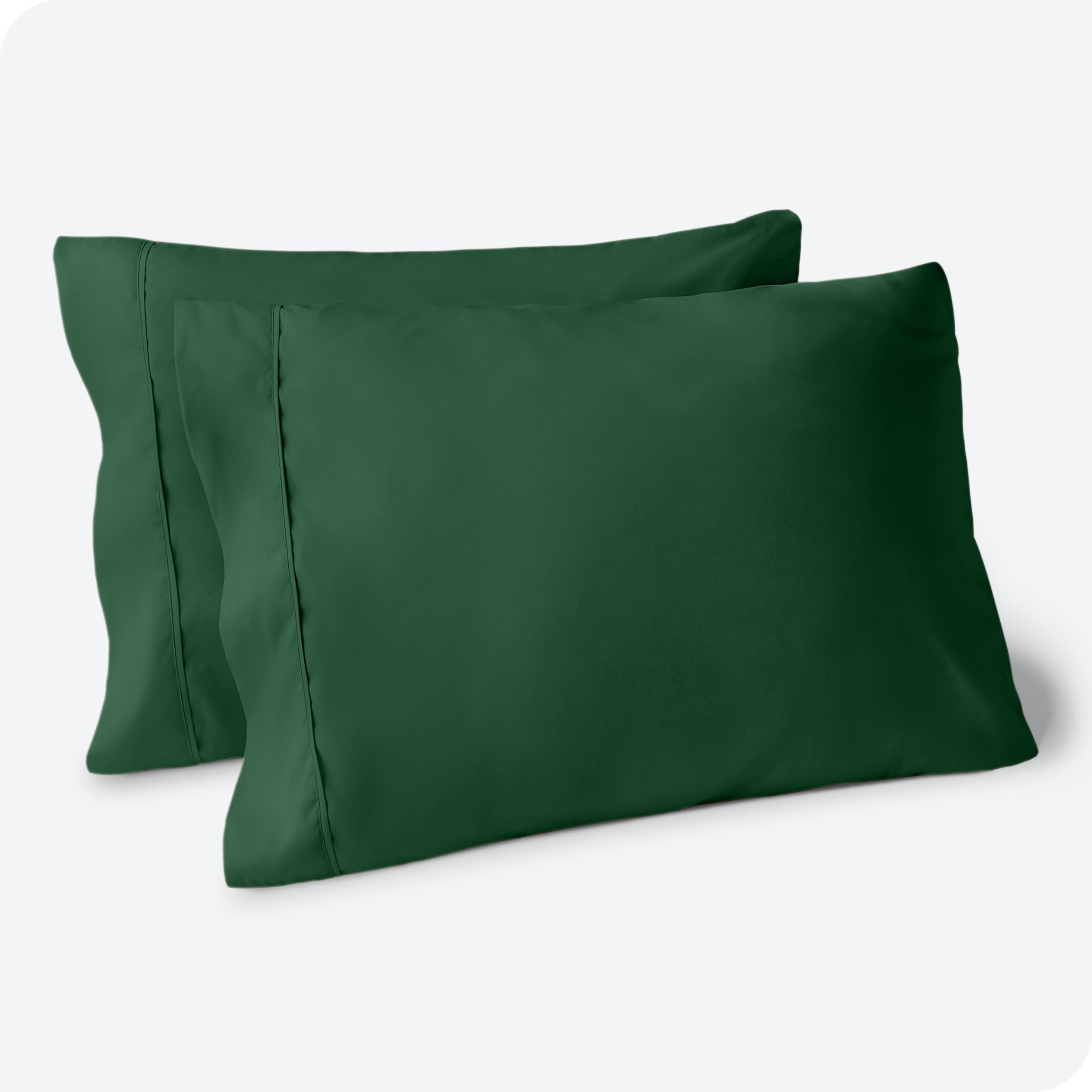 Two pillows on a white background with blue pillowcases on them