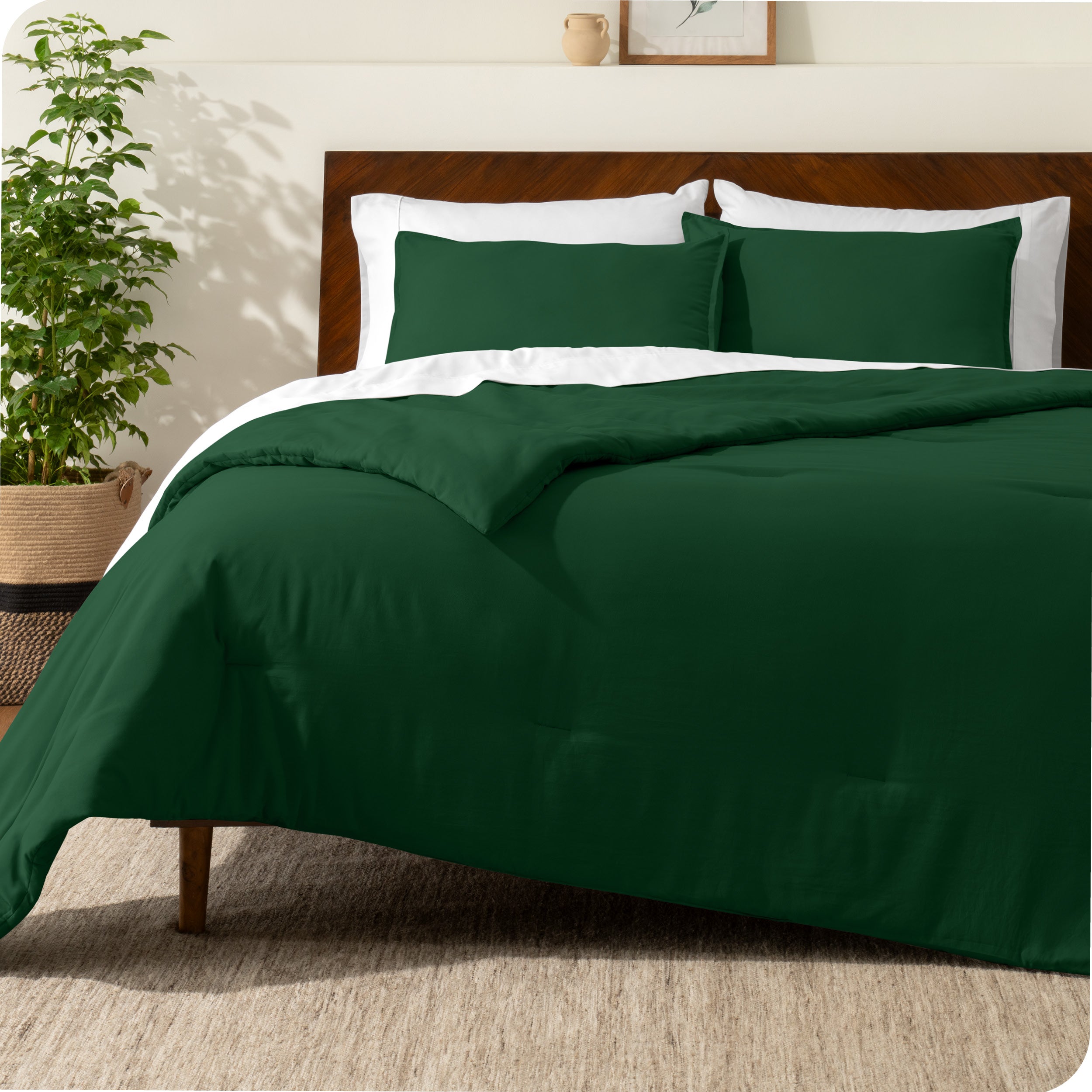 A comforter set on a bed with a dark wooden headboard