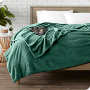 Microplush blanket laid out over a bed and folded back over itself