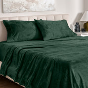 Microplush bed sheets and pillowcases on a bed with a neutral headboard and decor.
