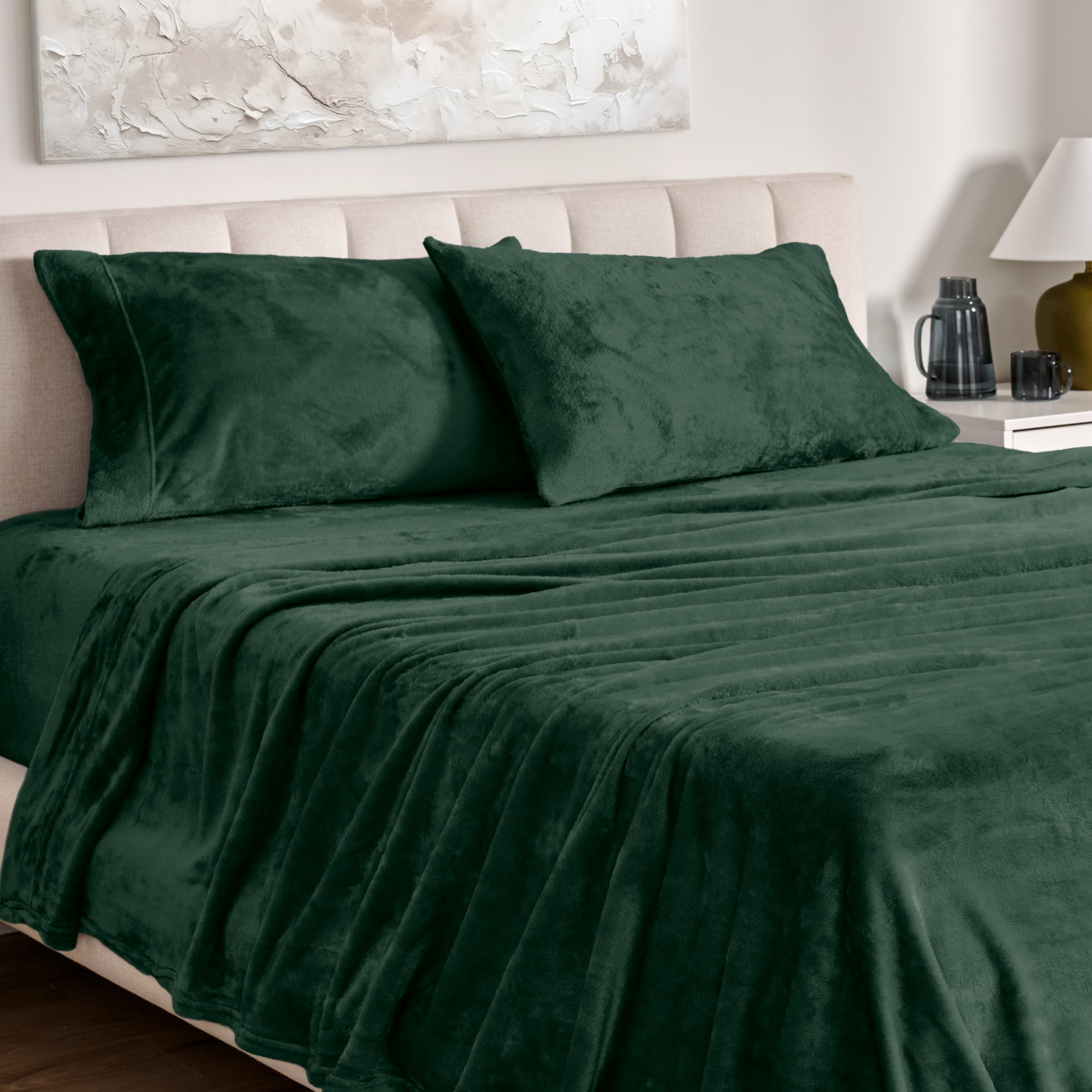 Microplush bed sheets and pillowcases on a bed with a neutral headboard and decor.