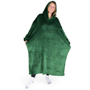 An adult is standing while wearing a long microplush wearable blanket