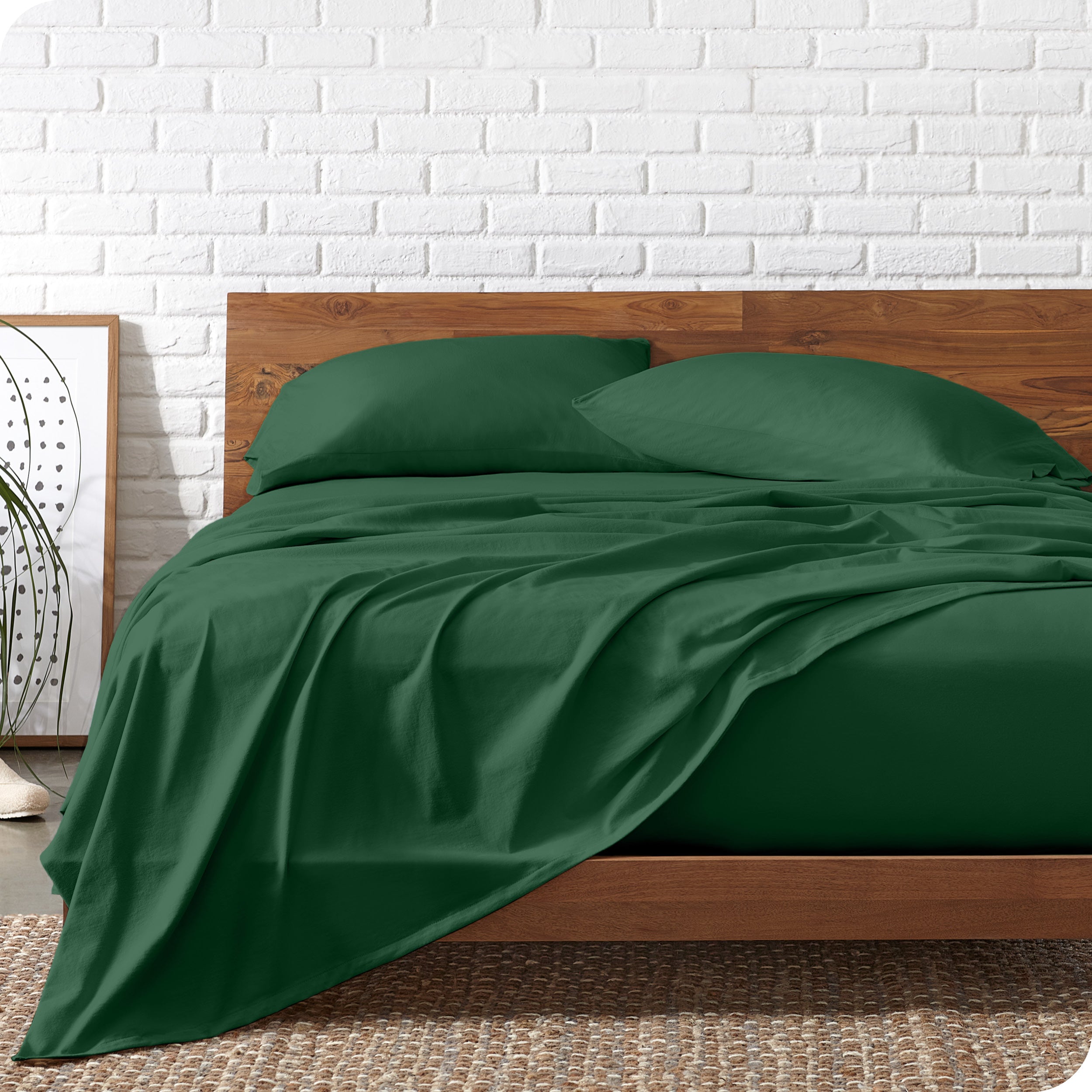 Organic jersey sheets on a bed with a wooden bed frame
