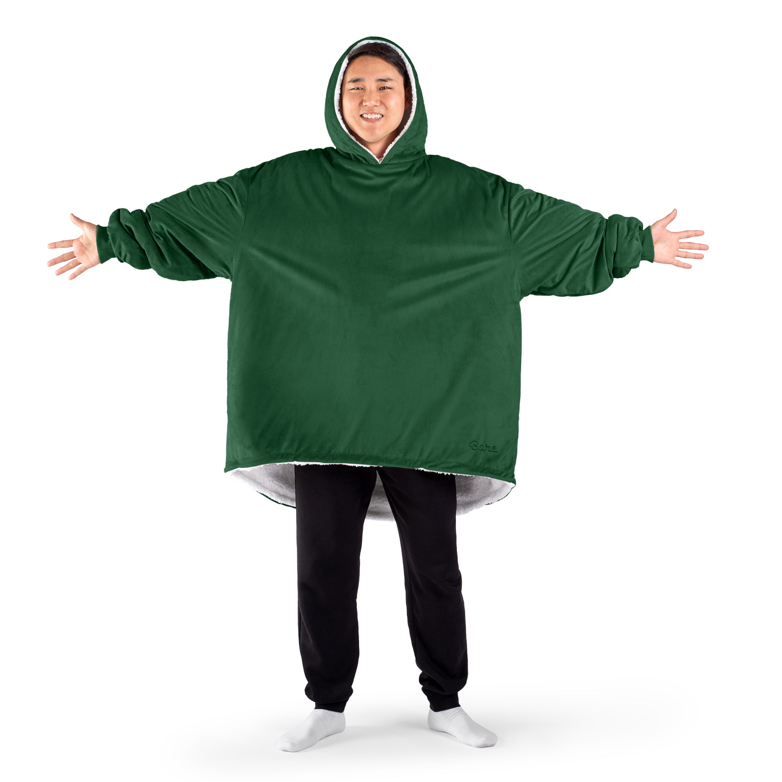 An adult with a sherpa wearable blanket on