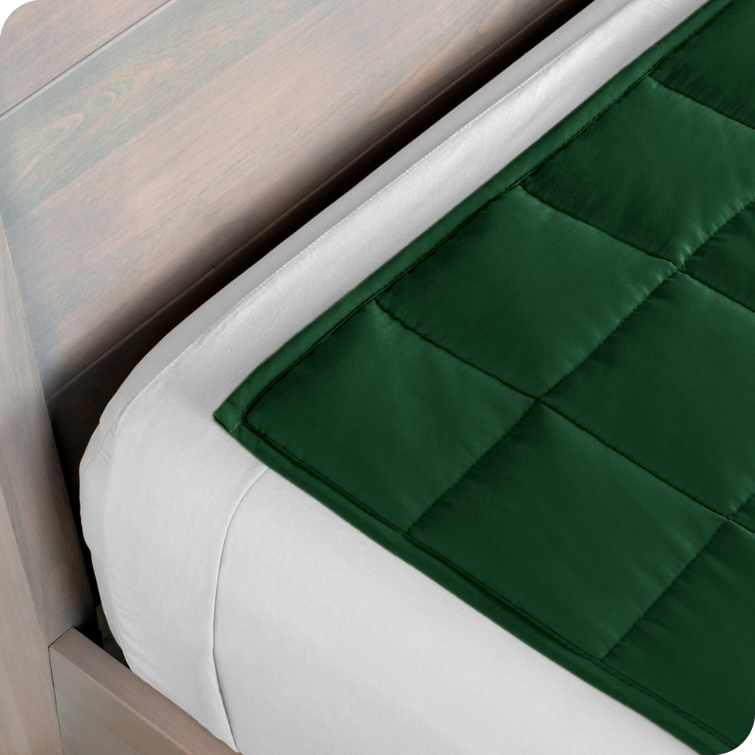 Close up of the corner of a weighted blanket on a bed