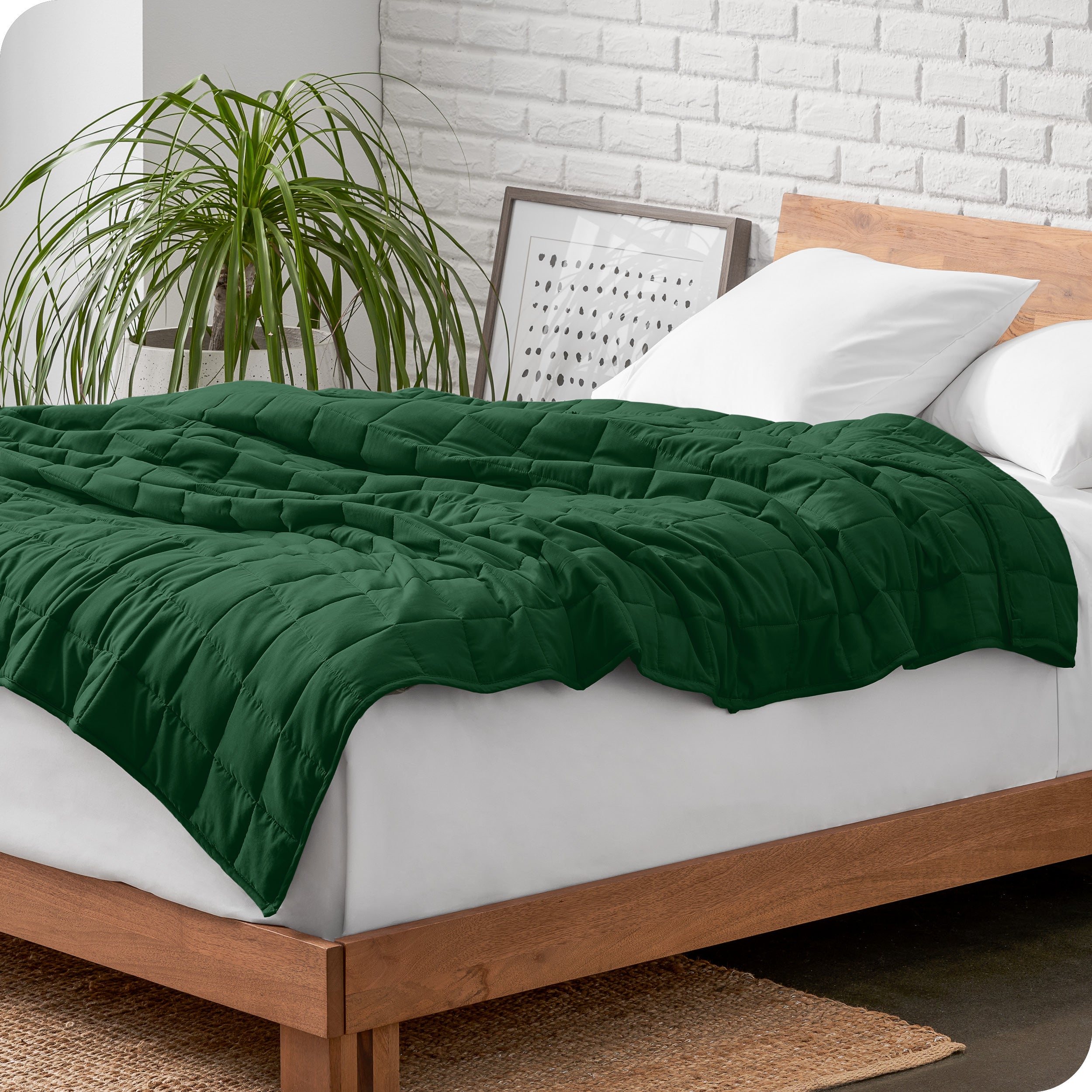 A cotton weighted blanket is loosely draped over a bed