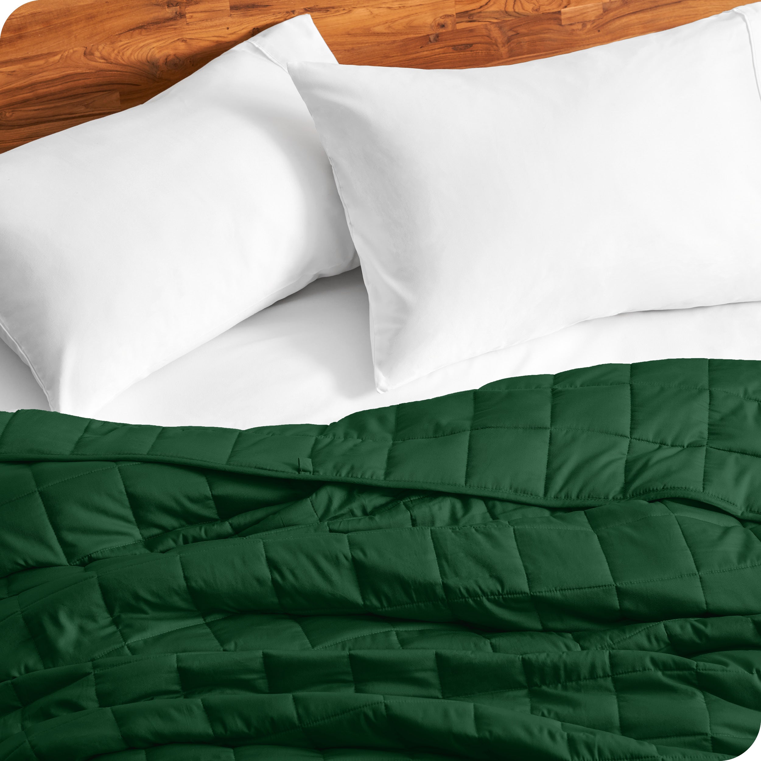 Close up of a weighted blanket on a bed with  2 pillows