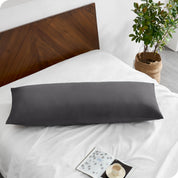 A body pillowcase on a pillow on a bed with all white bedding