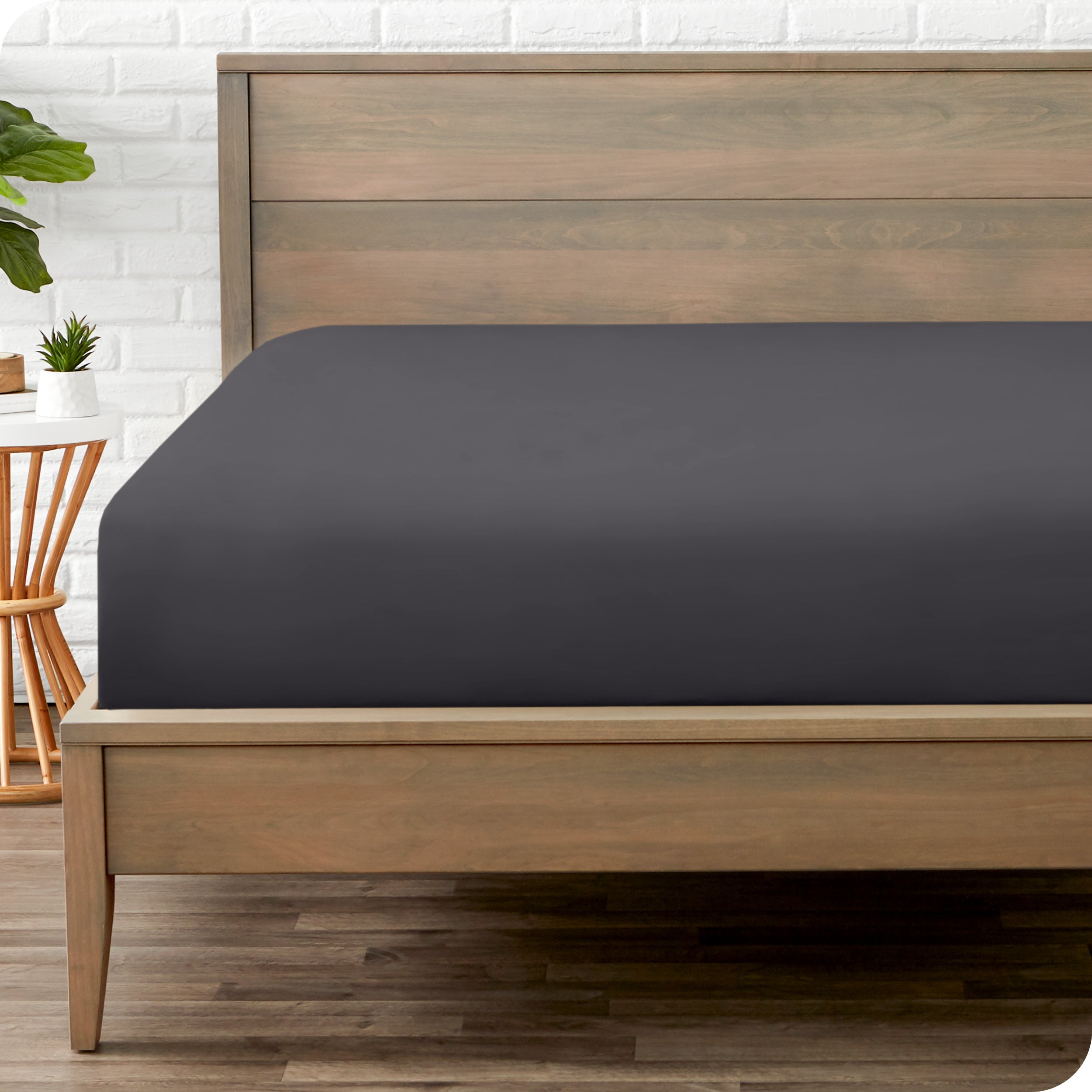 End of bed view with fitted sheet made on the mattress of a modern bed. 
