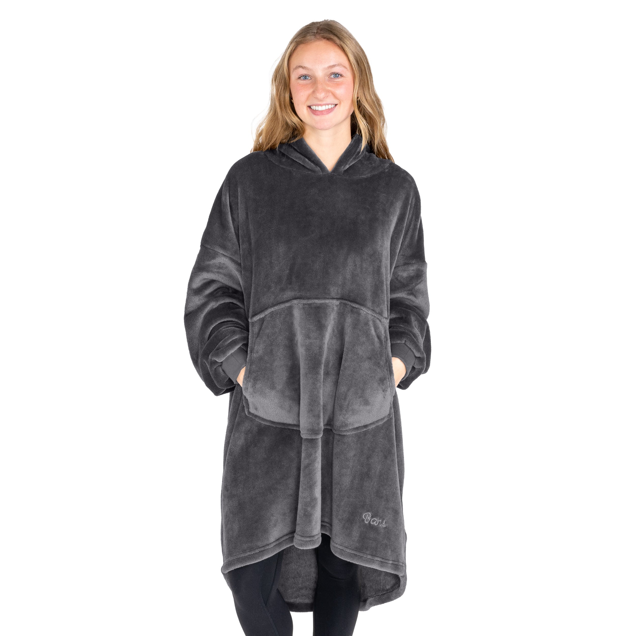 An adult with microplush wearable blanket on