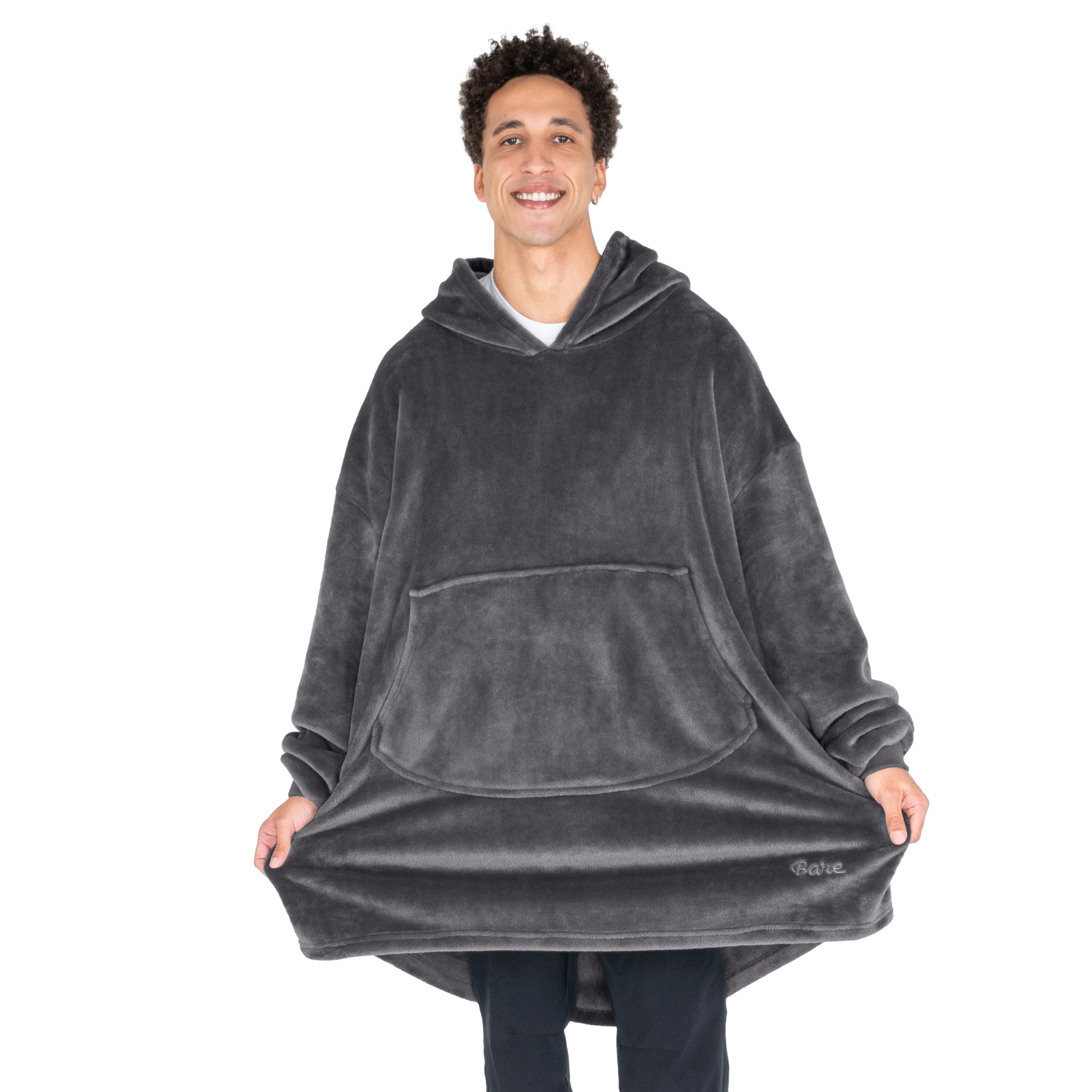 An adult with microplush wearable blanket on