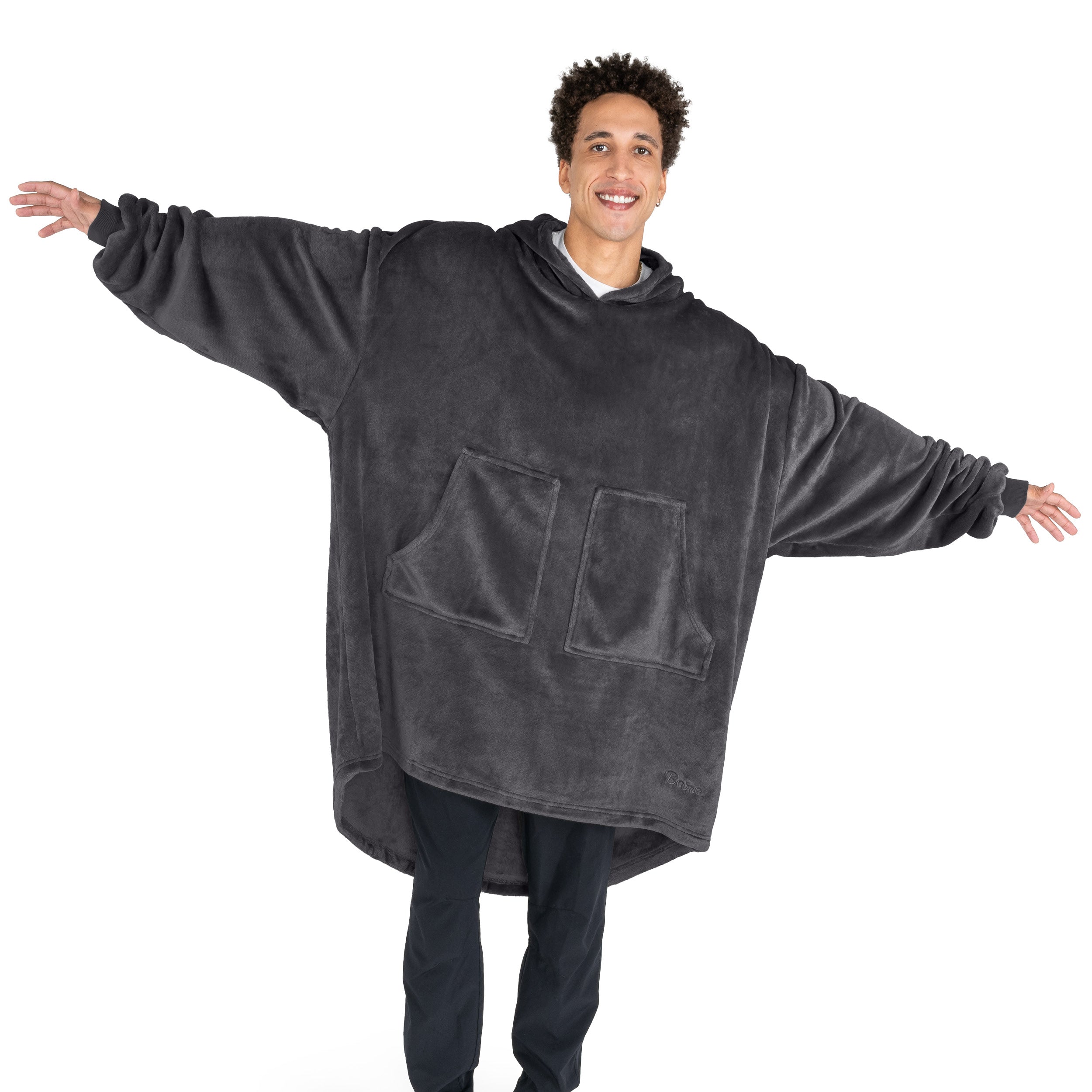 An adult with microplush wearable blanket on