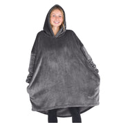 A woman is standing with a wearable blanket on