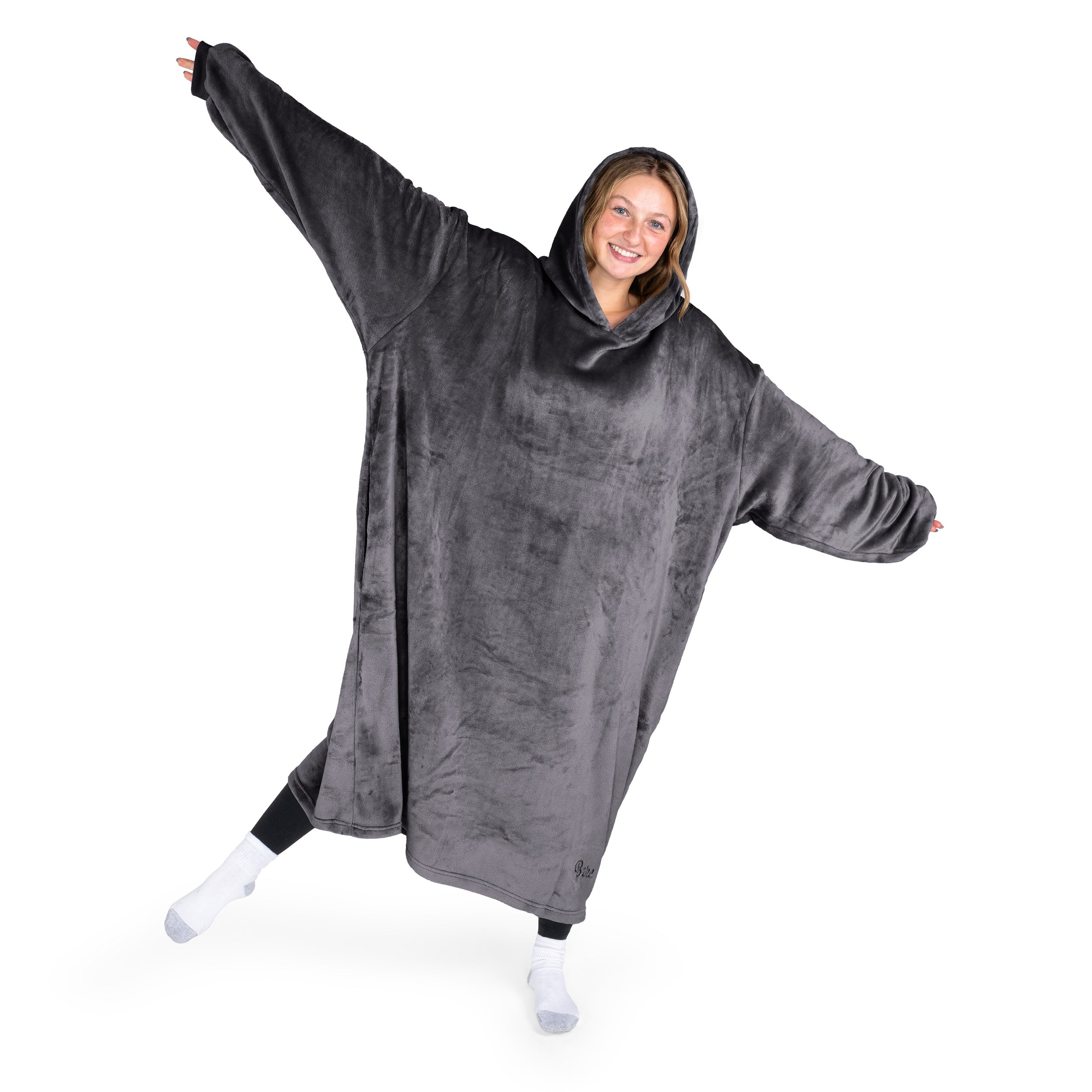 A woman has a hooded wearable blanket on