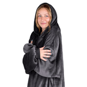 A woman is snuggled up in microplush wearable blanket