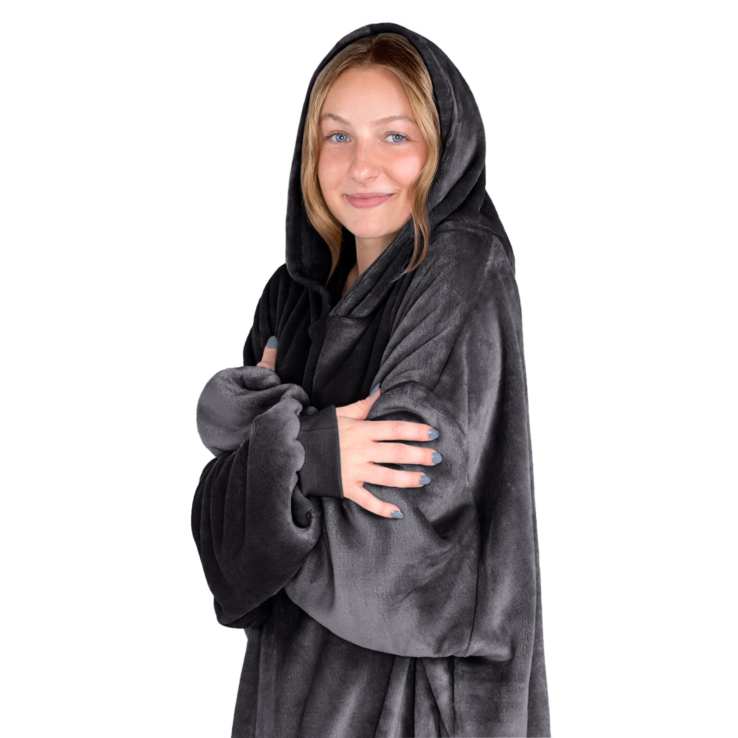 A woman is snuggled up in microplush wearable blanket