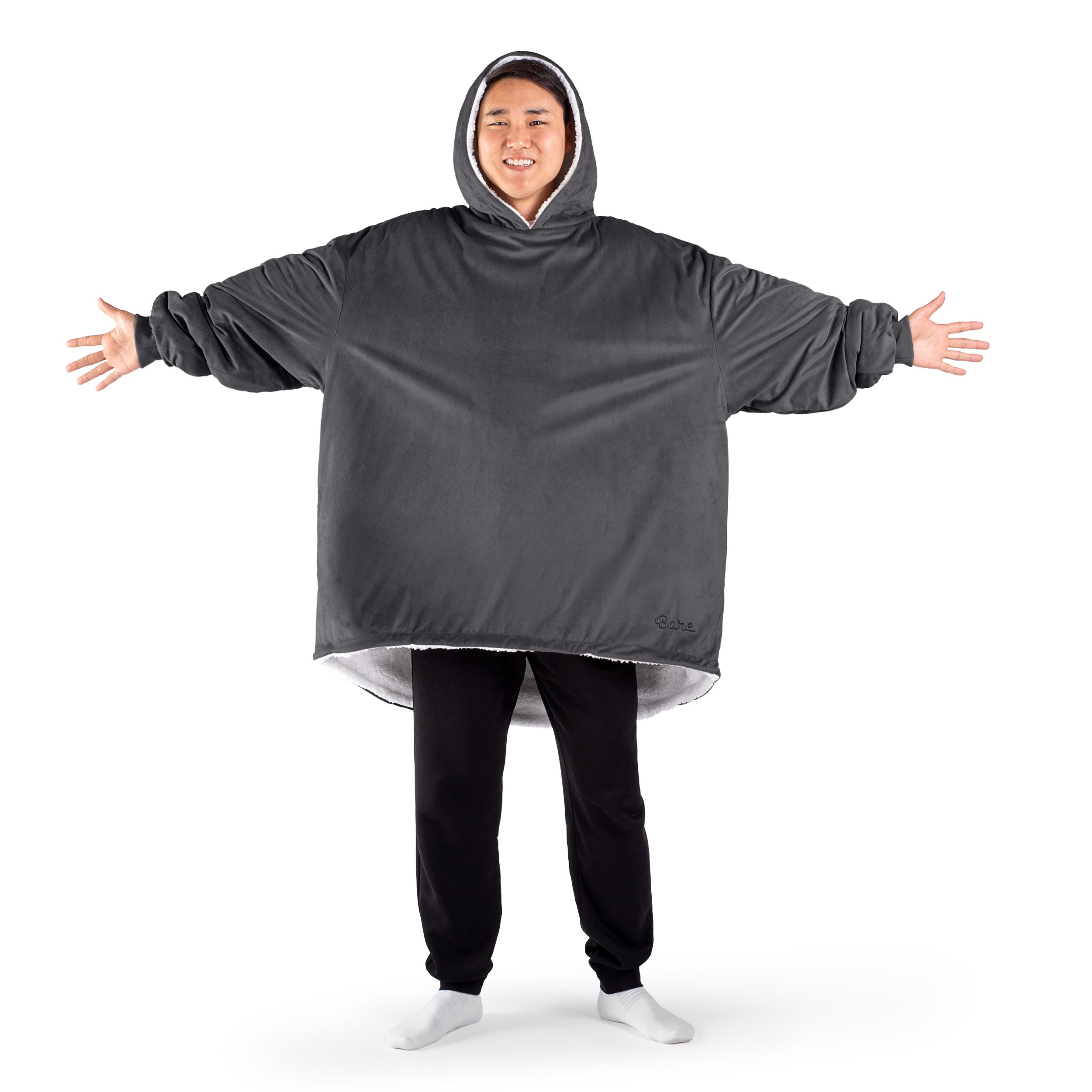 An adult with a sherpa wearable blanket on