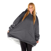 An adult with a sherpa wearable blanket on