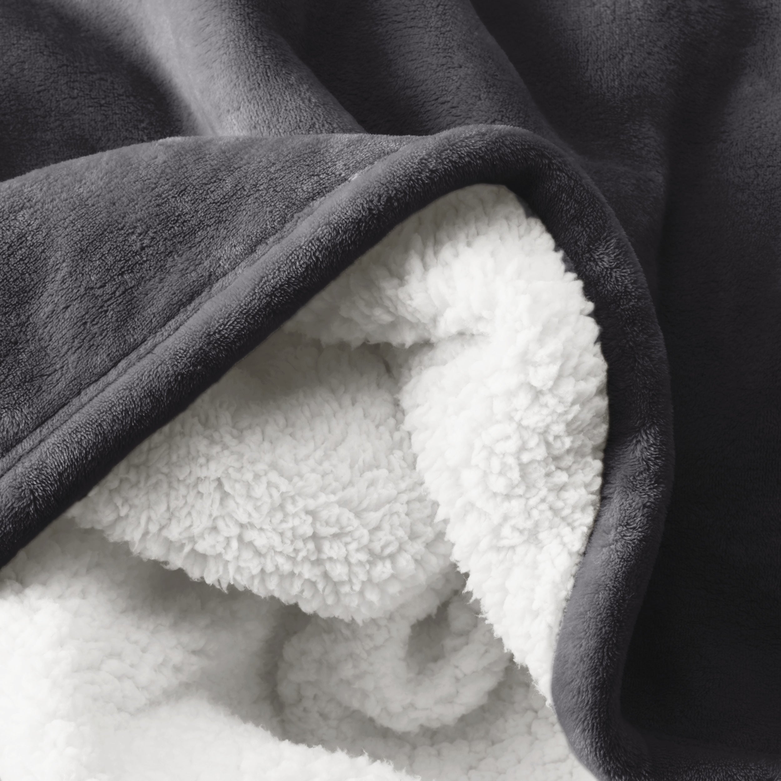 Close up of sherpa blanket showing texture of velvety soft side and sherpa backing