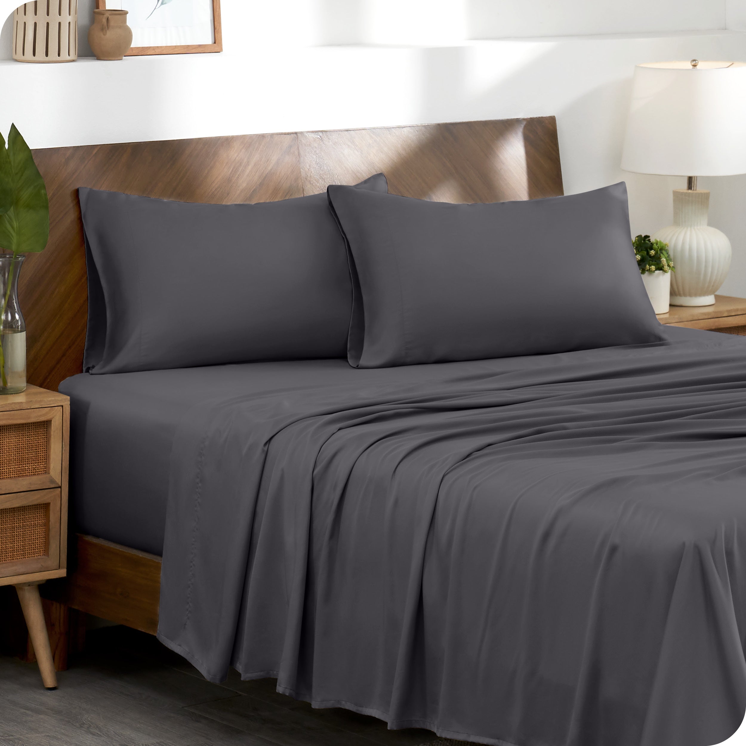 Two pillowcases on pillows on a bed with matching sheets