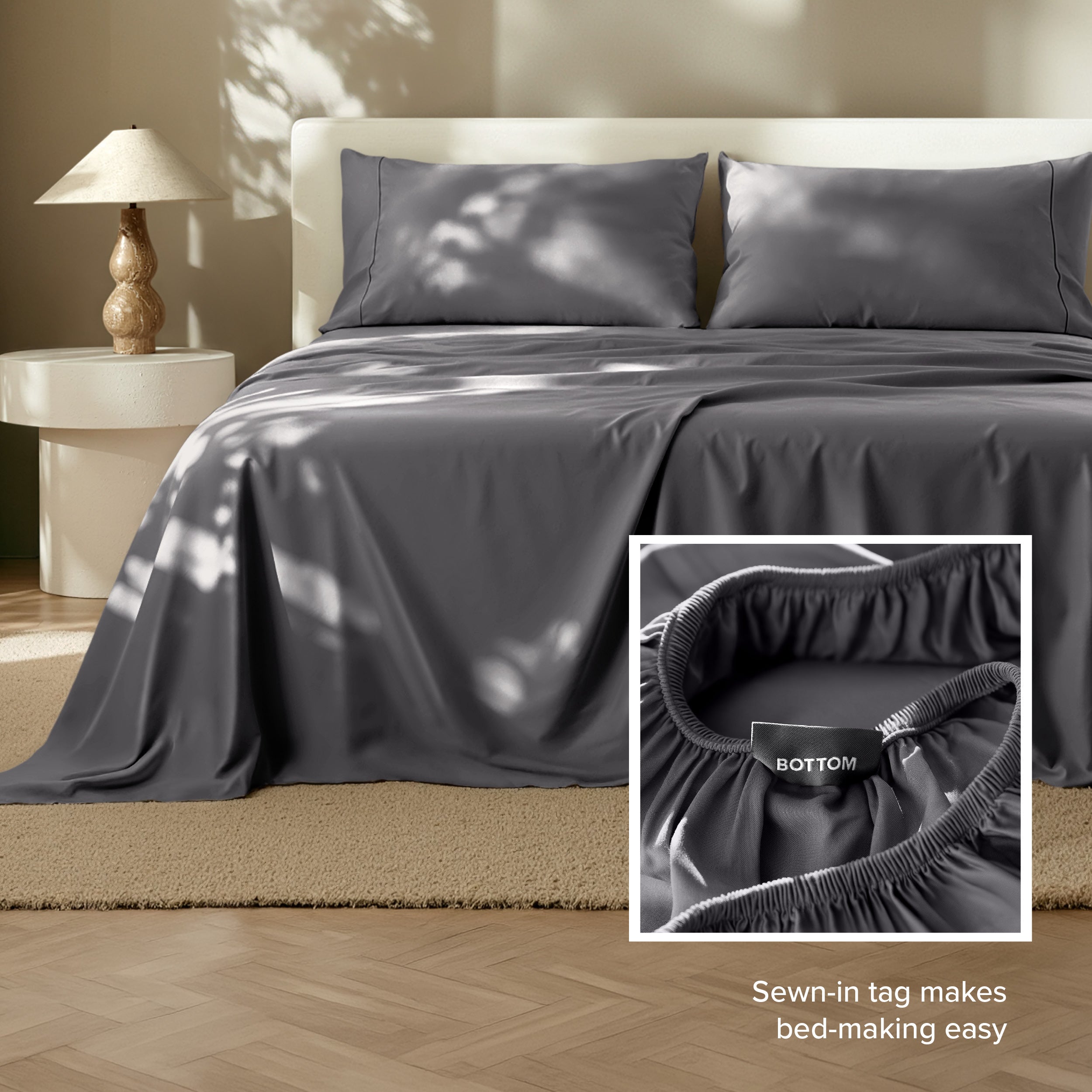 Tencel bed sheets on a bed with a lamp and side table in the background.