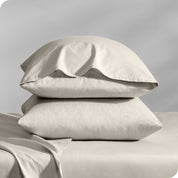 2 percale pillowcases on pillows set on a bed with matching sheets