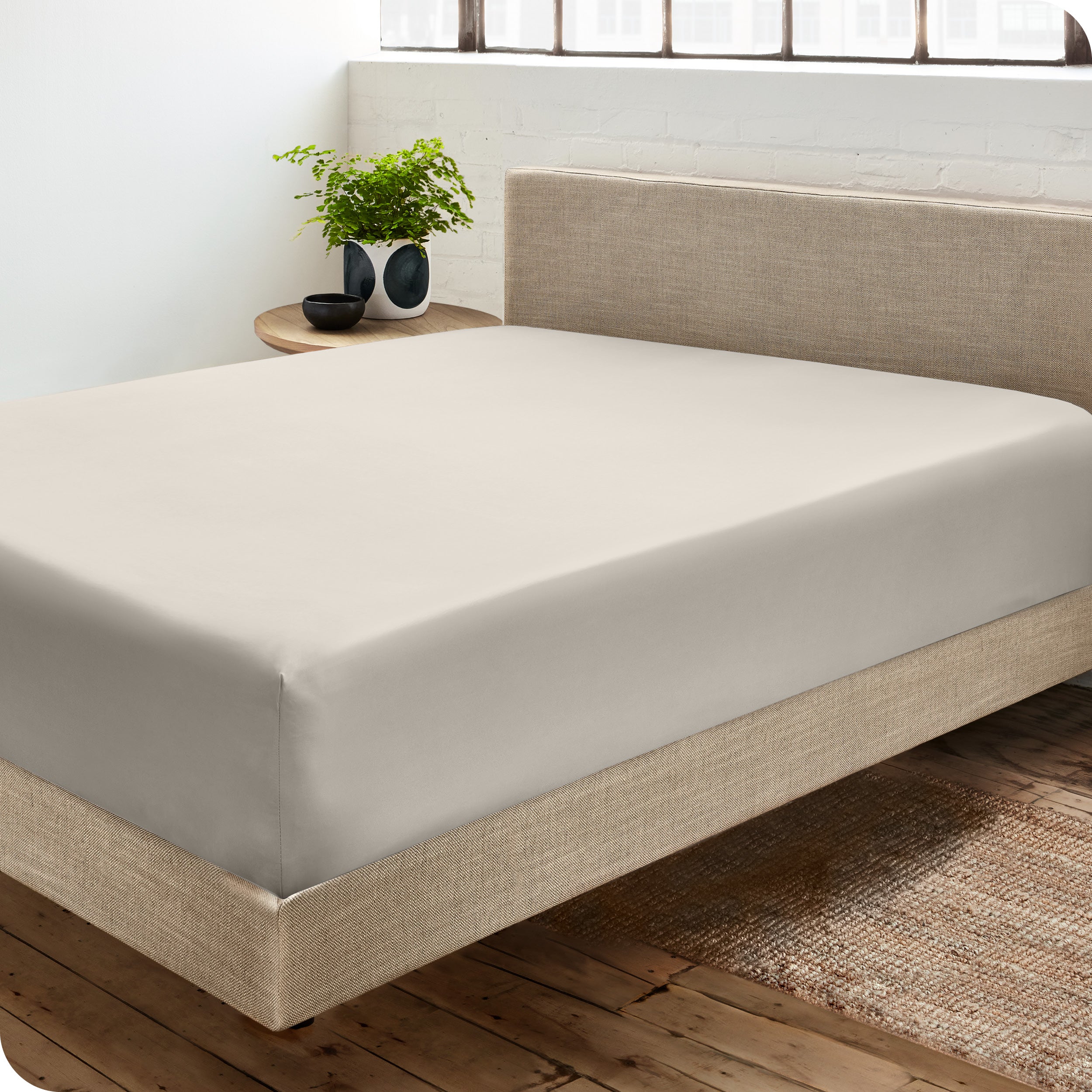 A sateen fitted sheet on a bed
