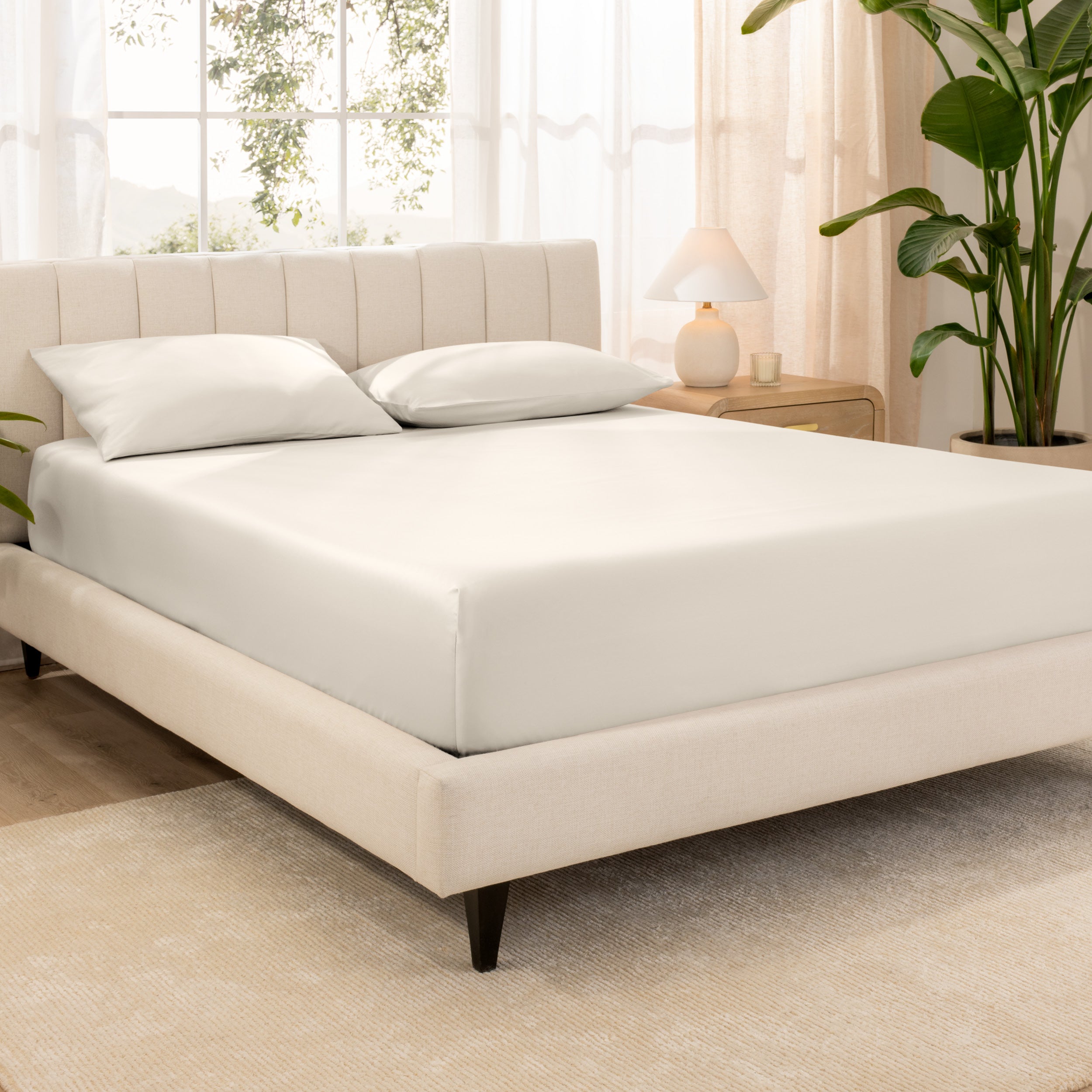 A sateen fitted sheet over a bed
