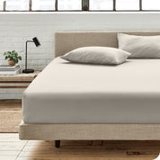 An organic cotton fitted sheet on a mattress