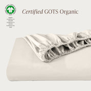 A single fitted sheet folded neatly showing part of the elastic. The fitted sheet is Certified GOTS Organic.