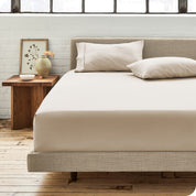 Percale fitted sheet on a mattress with matching pillowcases on pillows