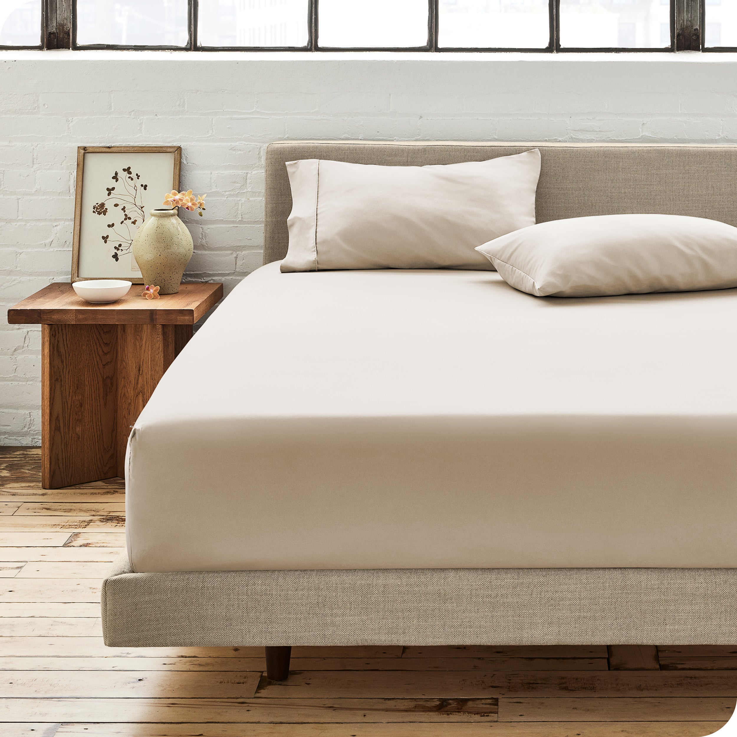 Percale fitted sheet on a mattress with matching pillowcases on pillows