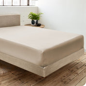 A single organic cotton fitted sheet on a bed
