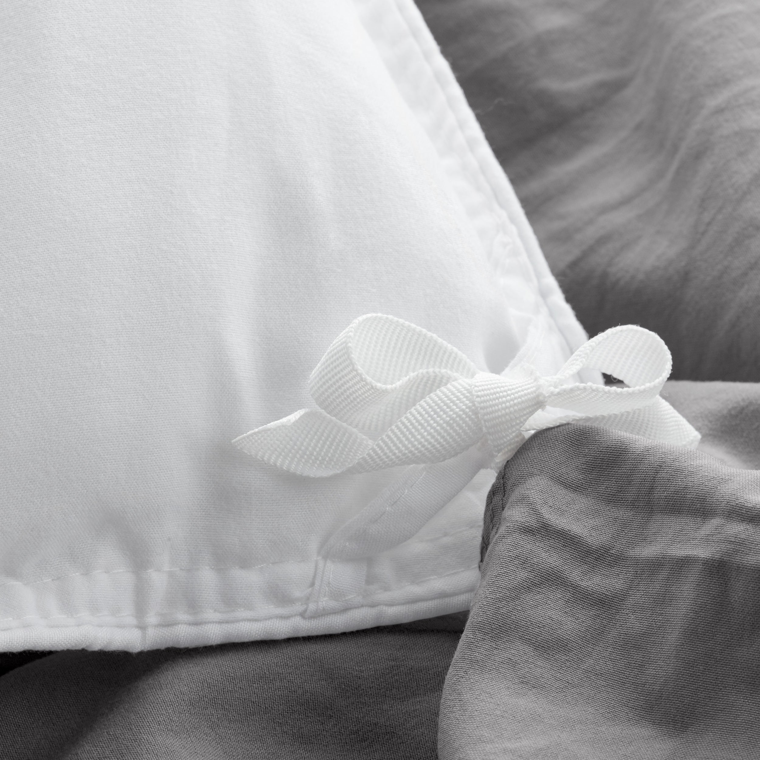 Close up of cloth ties for attaching duvet insert to inside of duvet cover