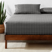 View for the end of a modern bed with a printed microfiber fitted sheet made with pillows. 
