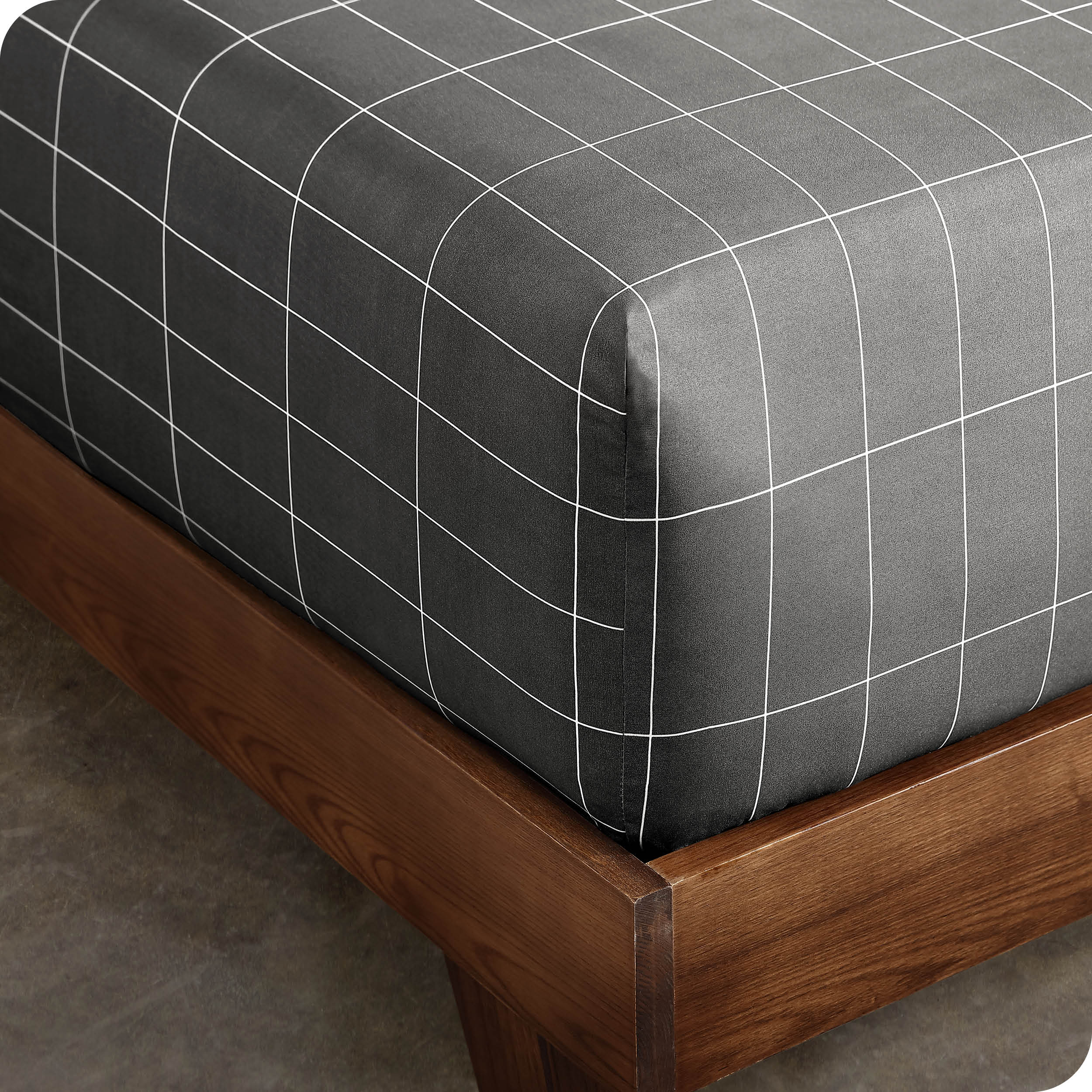 Close up view of the corner of a mattress with the microfiber fitted sheet to show how it fits. 