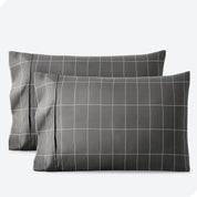 Two pillowcases on a white background with print pillowcases on them.