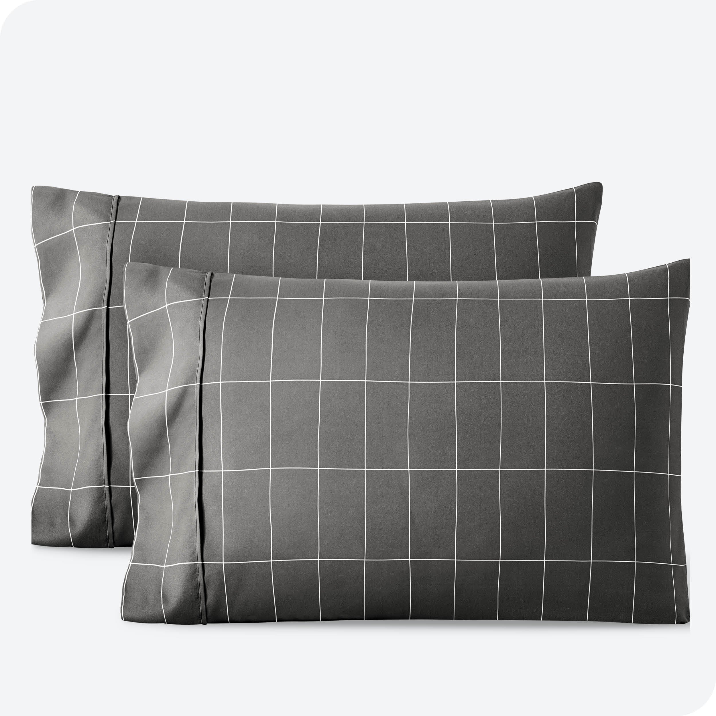 Two pillowcases on a white background with print pillowcases on them.