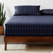 View for the end of a modern bed with a printed microfiber fitted sheet made with pillows. 
