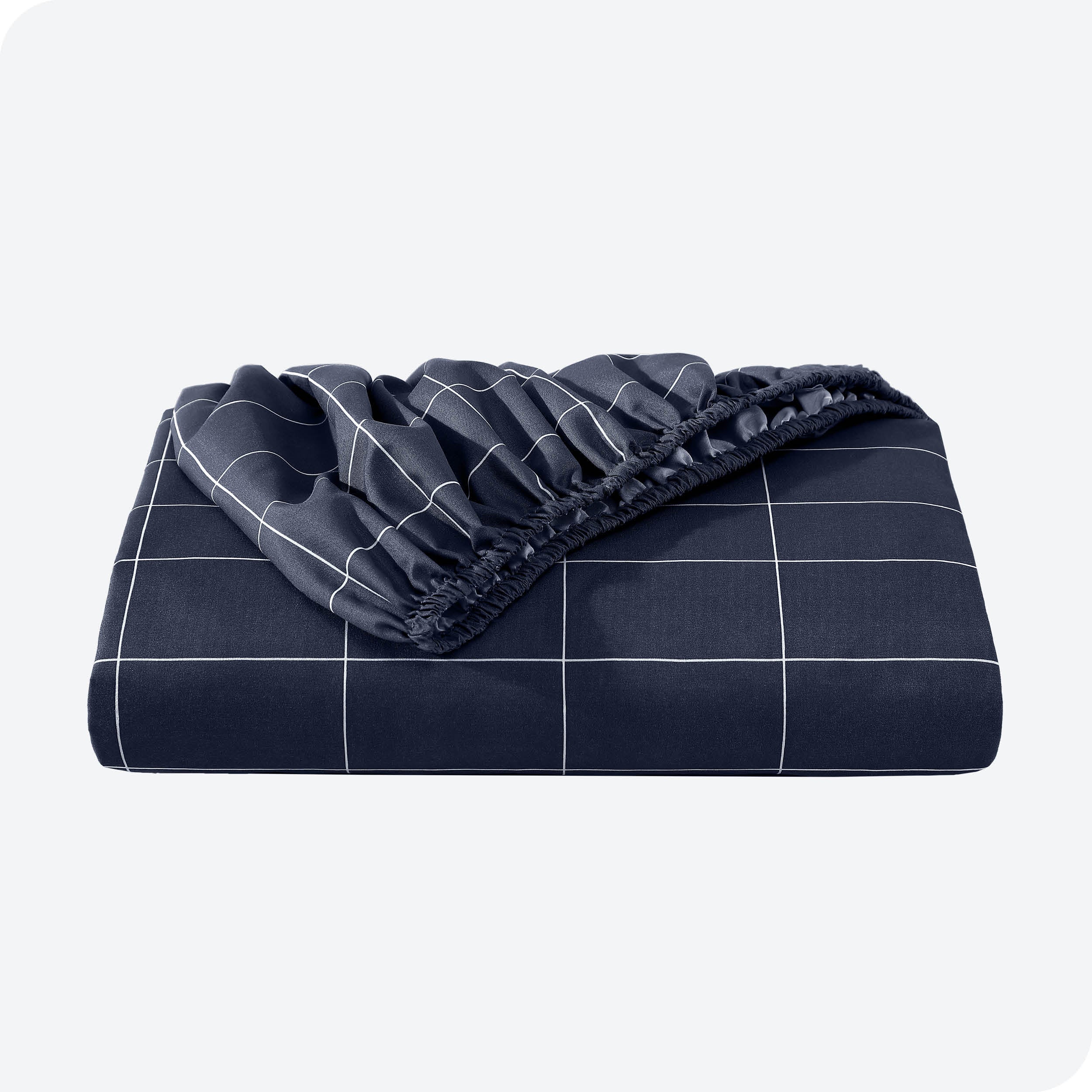A neatly folded printed microfiber fitted sheet with elastic draped. 