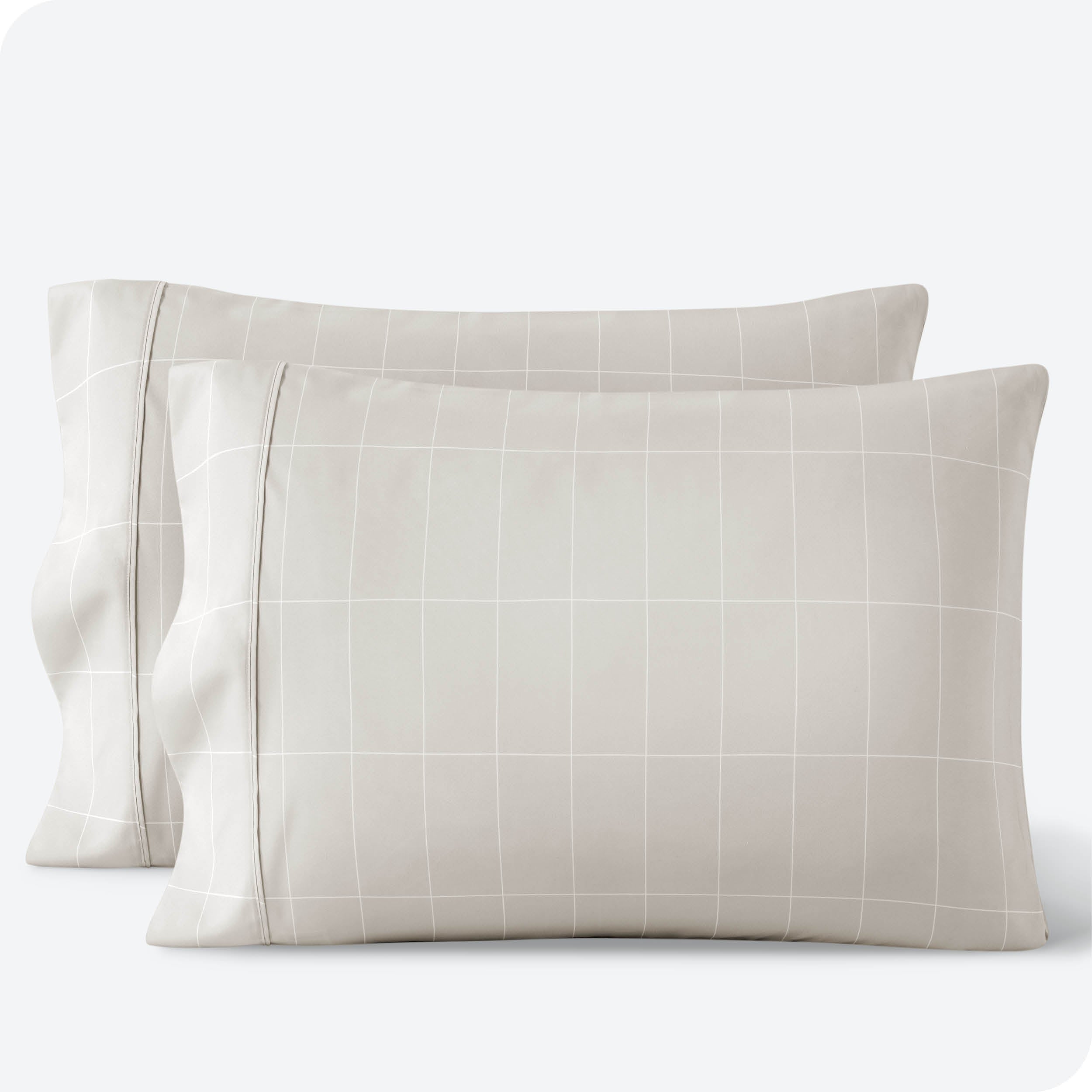 Two pillowcases on a white background with print pillowcases on them.