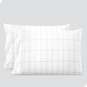 Two pillowcases on a white background with print pillowcases on them.